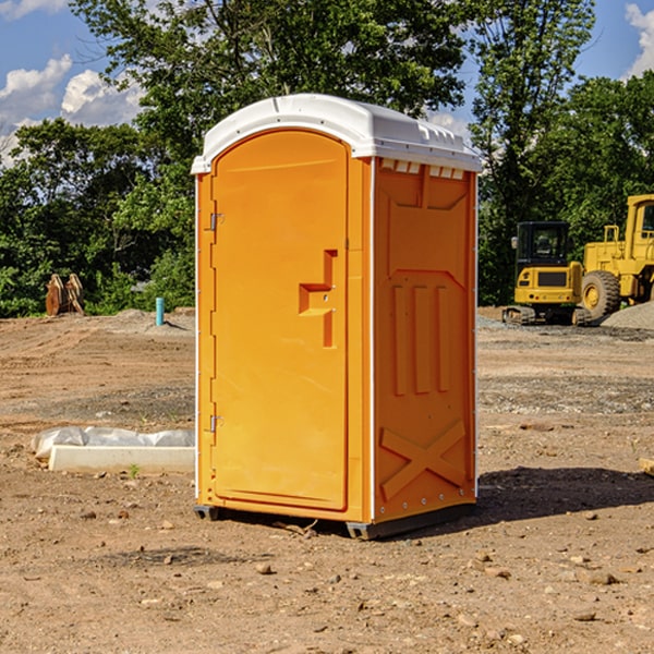 what is the cost difference between standard and deluxe portable toilet rentals in Amana